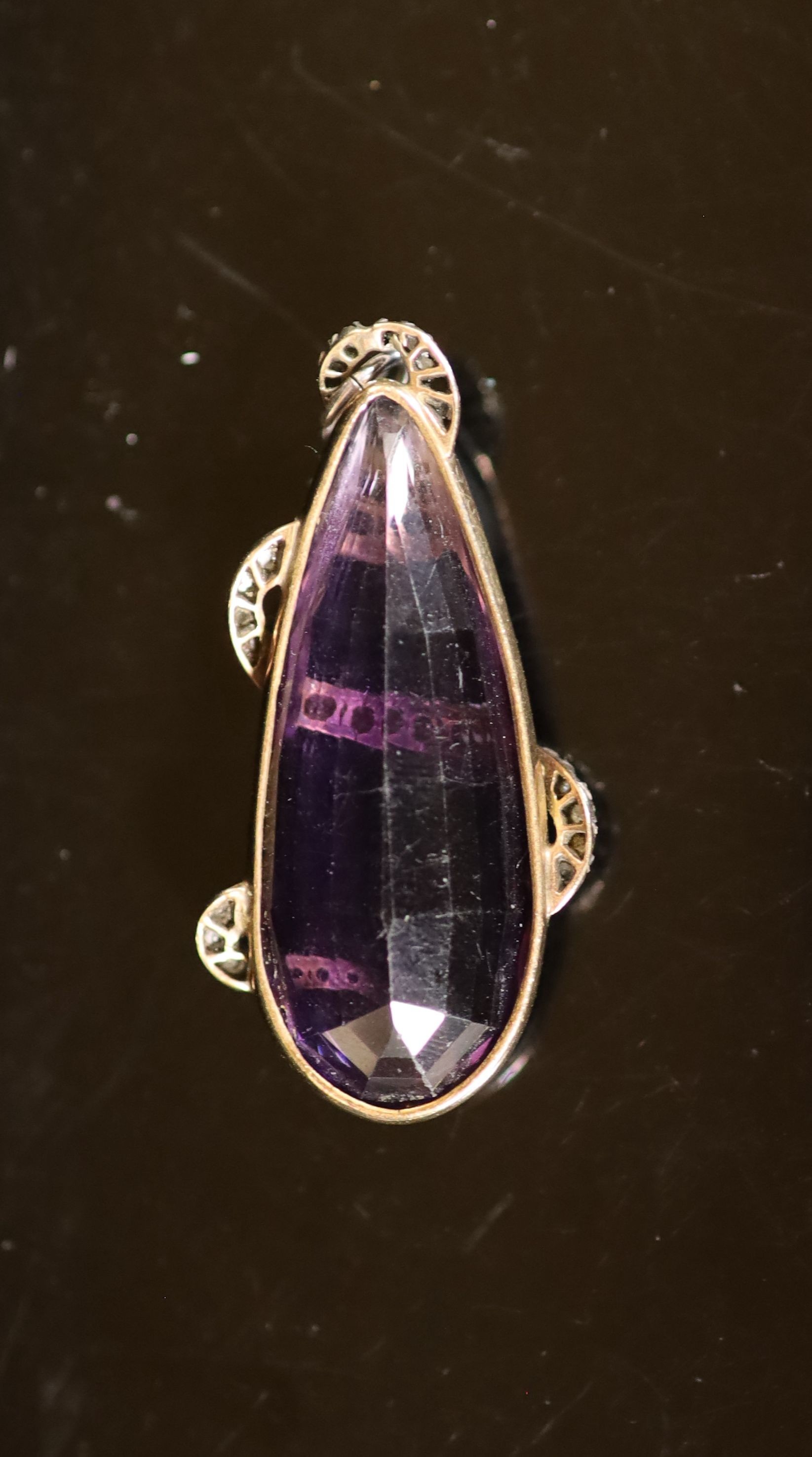 A Victorian gold mounted pear shaped amethyst pendant, entwined with diamond and ruby set serpent